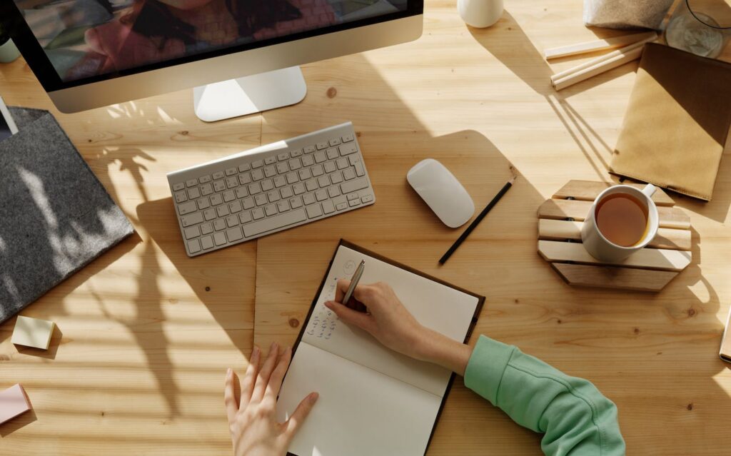 person writing on notebook